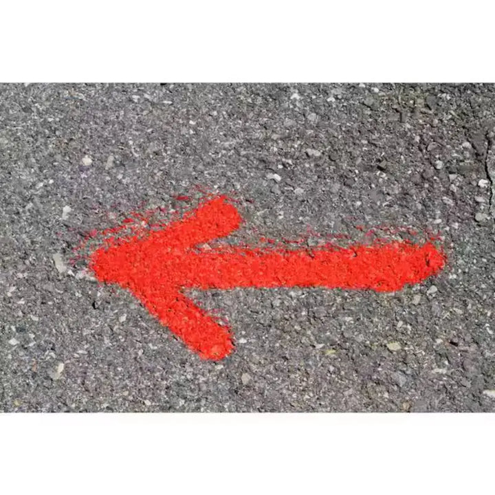 Seymour Fluorescent Orange Inverted Marking Paint shown with a painted arrow on concrete to show how bright it is