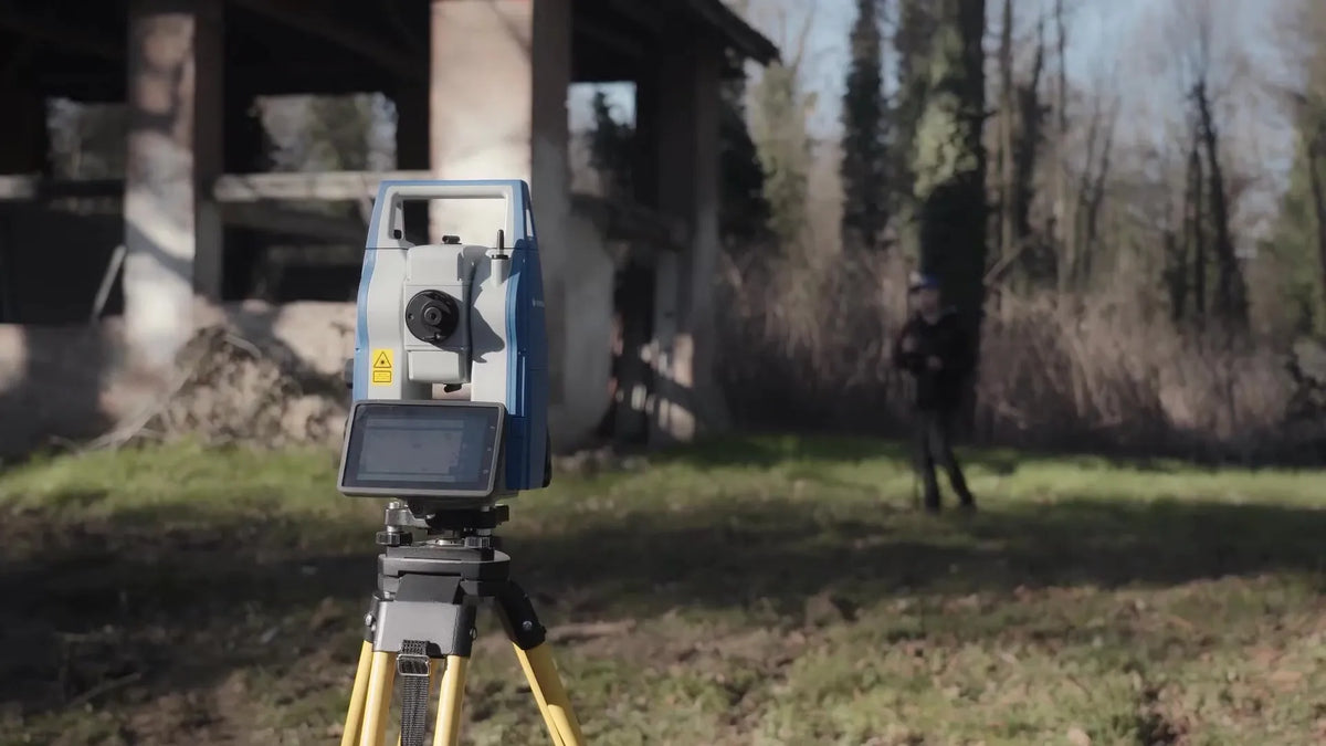 Stonex R180 locked onto a prism pole as a land surveyor is walking with a prism pole on a jobsite.