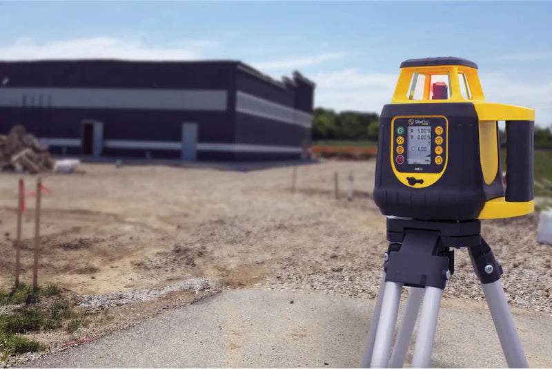 Construction Laser on a tripod in an outdoor setting with a building in the background
